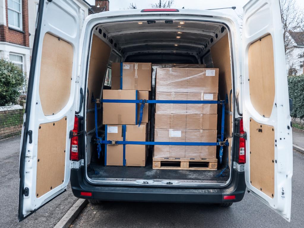 Open van loaded with securely strapped boxes